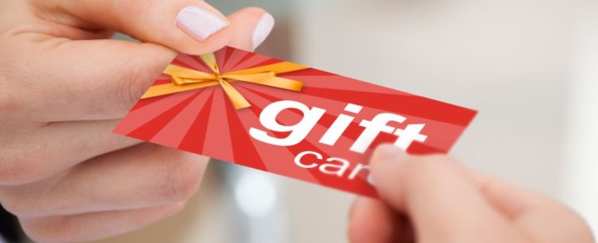 A person handing a gift card to someone.
