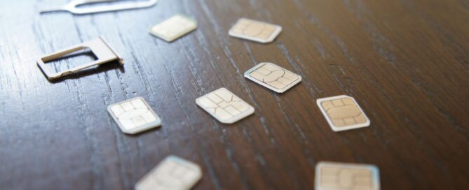 Nano SIM cards spread across a wooden table.